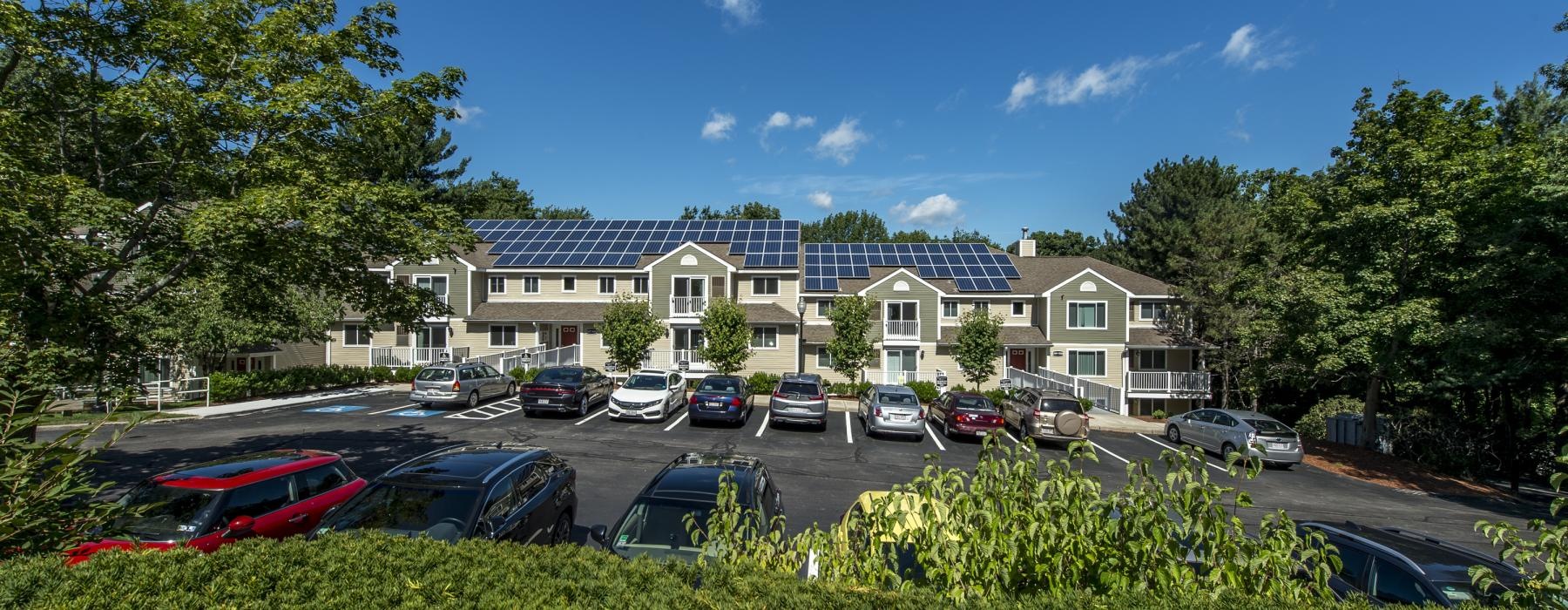 a parking lot with cars and houses