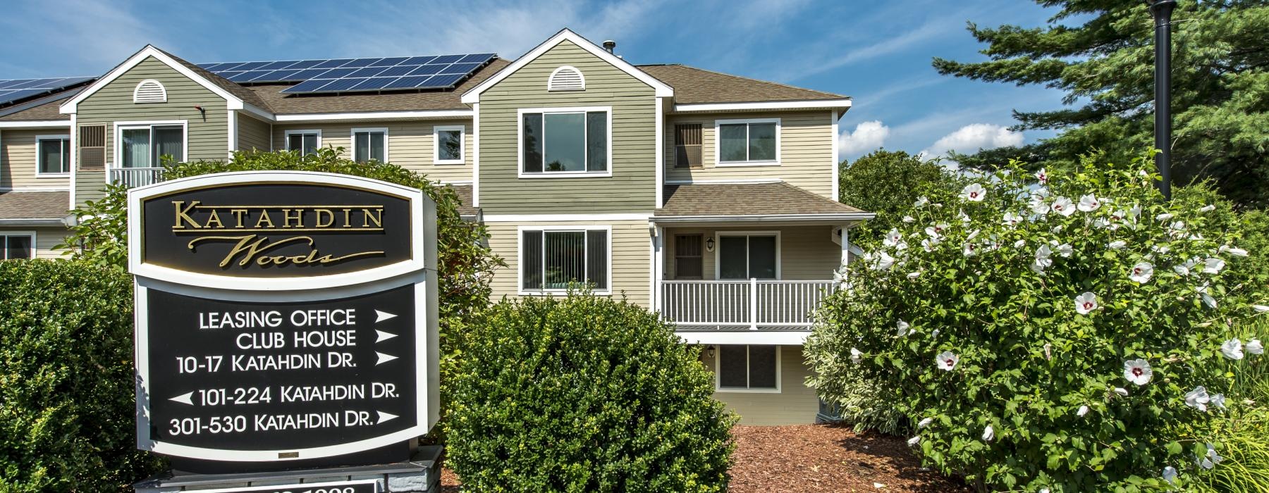 a large house with a sign in front of it